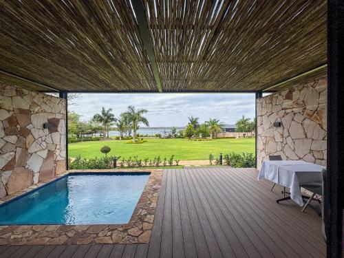 a patio with a pool and a table on a deck at Lira Boutique Lodge in Thohoyandou