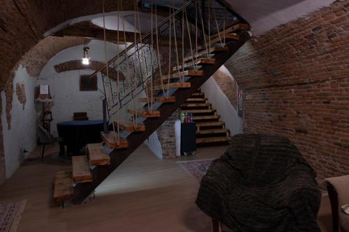 a staircase in a room with a brick wall at MAGISTER seven in Sibiu