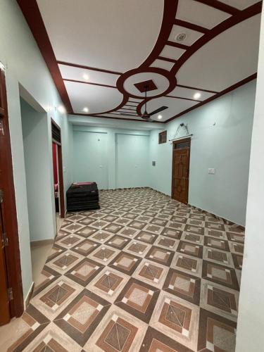an empty room with a tile floor and a ceiling at Riddhi Homestay in Ayodhya