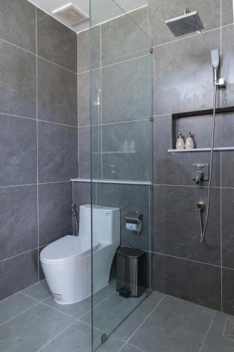 a bathroom with a toilet and a glass shower at Yen Hotel in Tuy Hoa