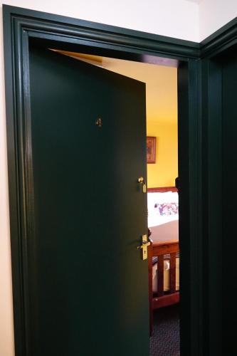 a door leading to a bedroom with a bed at Y Gwydyr Hotel - Dolwyddelan in Dolwyddelan