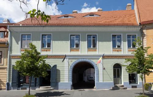 a large building with an archway in front of it at MAGISTER seven in Sibiu