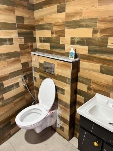a bathroom with a toilet and a sink at Golden palace studio in Noida