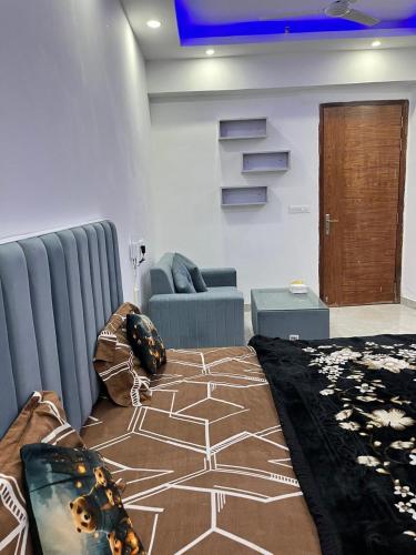 a living room with a bed and a couch at Golden palace studio in Noida