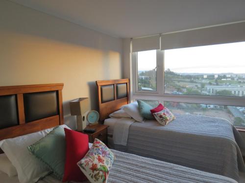 Un pat sau paturi într-o cameră la Concepción Suites