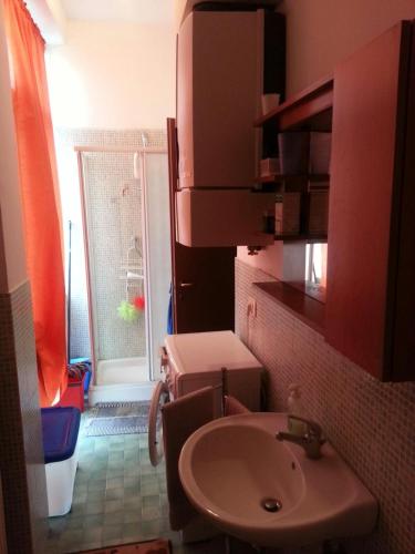 a small bathroom with a sink and a window at La Persiana in Ancona