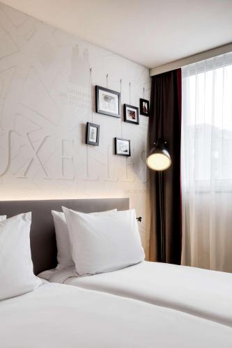 Un ou plusieurs lits dans un hébergement de l'établissement Pentahotel Brussels Airport
