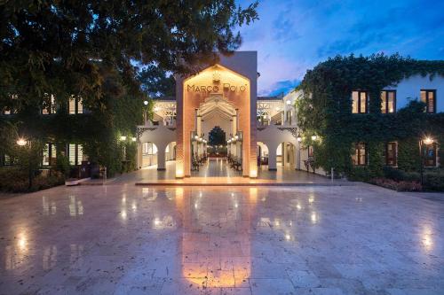 a building with a fountain in the middle of a courtyard at Club Marco Polo - Premium All Inclusive in Kemer