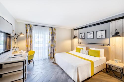 a hotel room with a bed and a desk at Club Marco Polo - Premium All Inclusive in Kemer