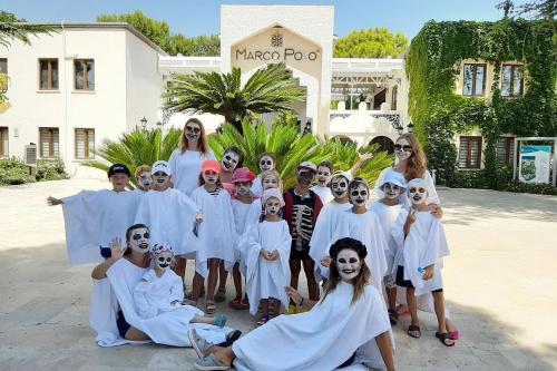 a group of people dressed in white posing for a picture at Club Marco Polo - Premium All Inclusive in Kemer
