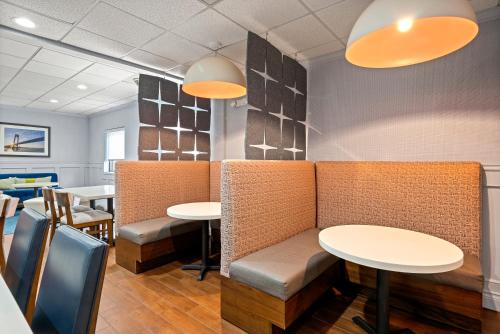 a dining room with tables and chairs and lights at Hampton Inn Bordentown in Bordentown