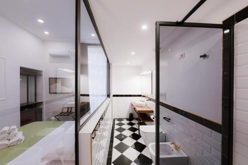 a bathroom with a black and white checkered floor at Raggio di Sole in Maiori