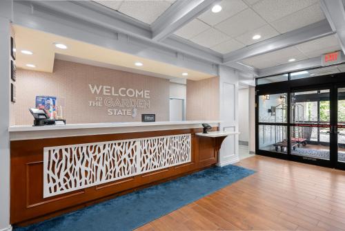 a lobby with a welcome to the garden state sign on the wall at Hampton Inn Bordentown in Bordentown