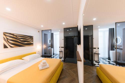 a bedroom with a yellow bed and a bathroom at Raggio di Sole in Maiori