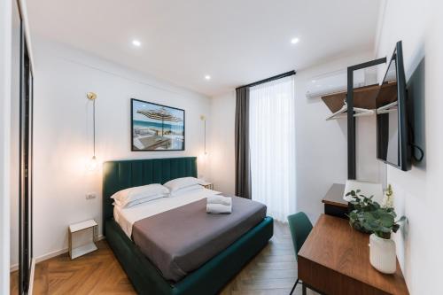 a bedroom with a bed with a green headboard at Raggio di Sole in Maiori