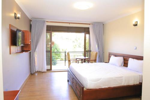 Postel nebo postele na pokoji v ubytování Tezor Hotel Entebbe
