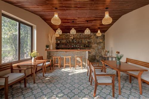a dining room with wooden tables and chairs at Trang An Aroma Ecolodge Ninh Binh in Ninh Binh