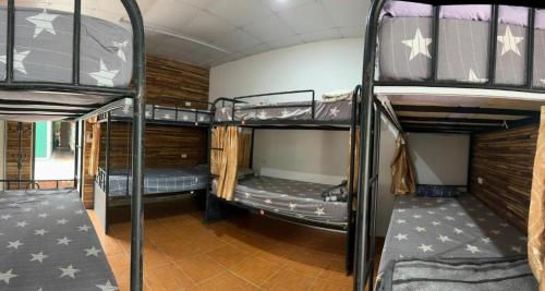a room with three bunk beds in a house at Ha Giang Eco Bungalow in Ha Giang