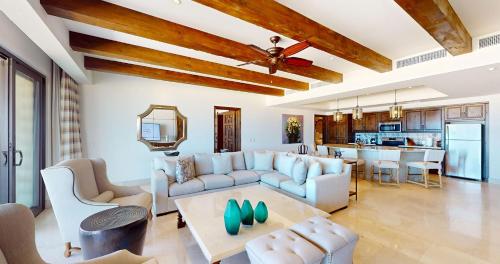 a living room with a couch and a table at Grand Solmar Pacific Dunes Resort, Golf & Spa in Cabo San Lucas