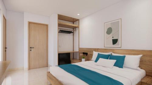 a bedroom with a large bed with blue and white pillows at Yen Hotel in Tuy Hoa
