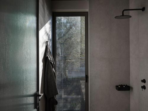 a bathroom with a large window in a room at Noero Villas Lefkada in Lefkada Town