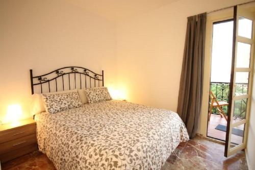 a bedroom with a bed and a window at Mansión Alhamar Beachfront in Sitio de Calahonda
