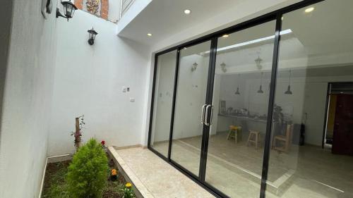 a room with glass doors on the side of a building at Malka Casas - Hoteles in Marco
