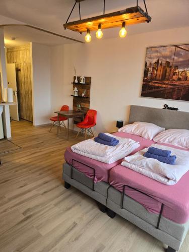 a bedroom with two beds and a table with chairs at Cityapartments MH in Mülheim an der Ruhr