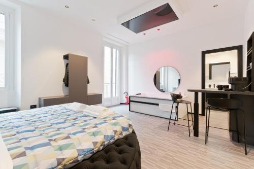 a bedroom with a bed and a desk and a mirror at Poerio 40 in Pescara