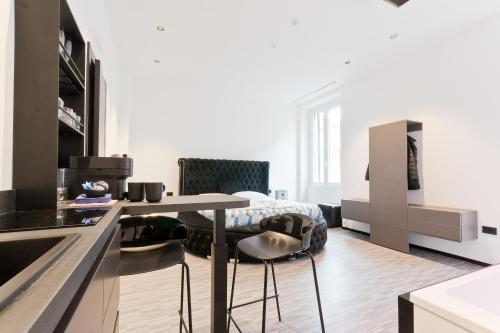 a kitchen with a table and chairs in a room at Poerio 40 in Pescara