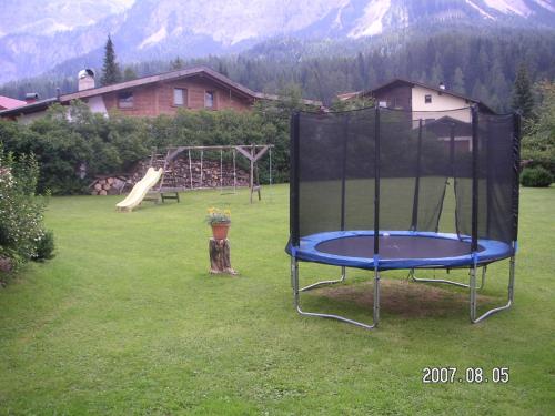 a playground with a trampoline in a yard at Gästehaus Haag in Ehrwald