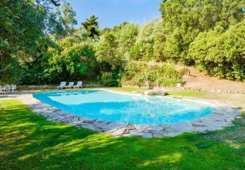 - une piscine avec deux chaises dans la cour dans l'établissement Le Domaine de L'avelan - vue mer, à Tanneron