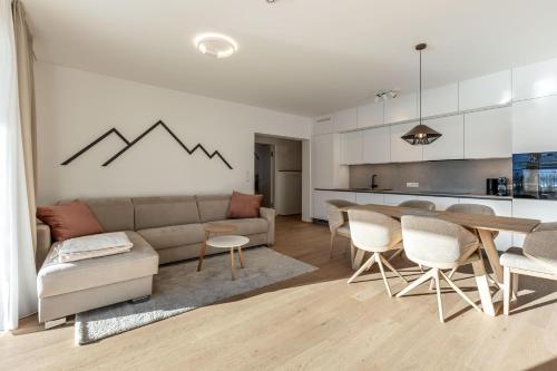 a living room with a couch and a table at Alpine Suite Spot in Bad Mitterndorf
