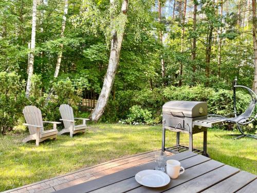 Zahrada ubytování Mazursko - komfortowe apartamenty nad jeziorem, sauna, kominki na parterze