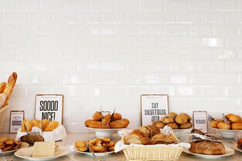 a table topped with lots of different types of bread at Ocean Beach Club Gran Canaria in Mogán
