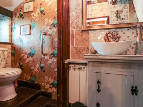 ein Badezimmer mit Toilette und Waschbecken in der Unterkunft The Old Mill Cottage in Whitby