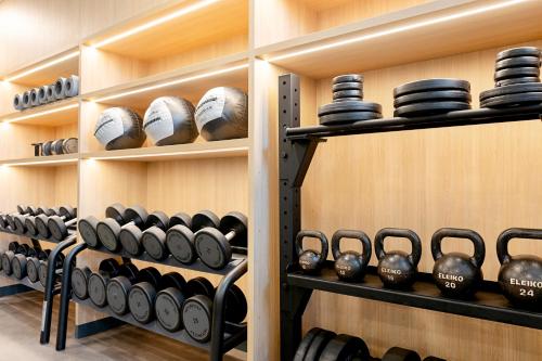 a room with shelves filled with dumbbells and bowls at Ocean Beach Club Gran Canaria in Mogán