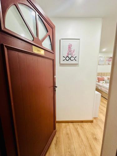 a wooden door in a room with a hallway at GuestReady - Amazing Studio near Disneyland in Montévrain