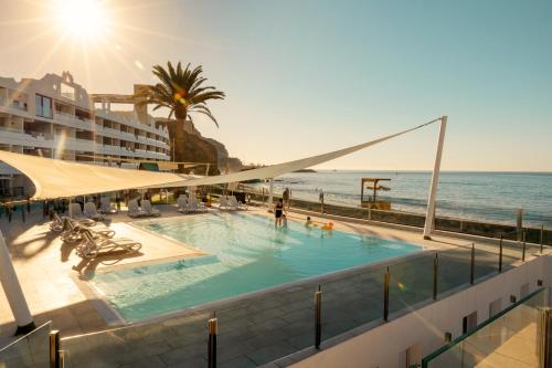 a swimming pool with the ocean in the background at Ocean Beach Club Gran Canaria in Mogán