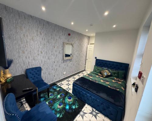 a living room with a couch and a bed at Marble blue flat, City of Gloucester in Gloucestershire