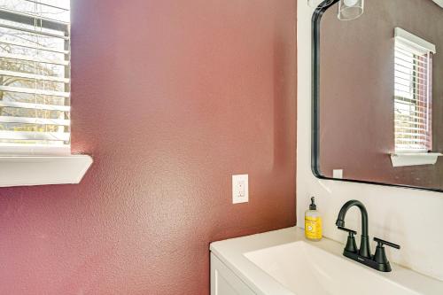 a bathroom with a sink and a mirror at Convenient Bryan Townhome with Patio Less Than 3 Mi to AandM! in Bryan