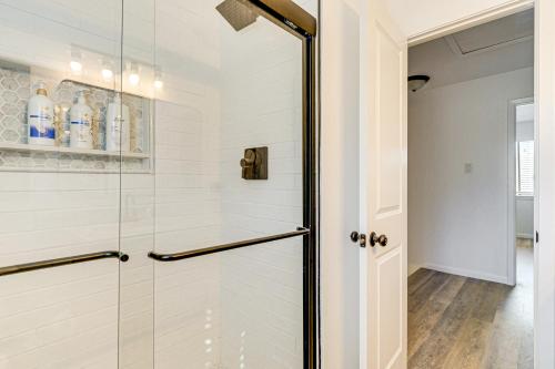 a shower with a glass door in a bathroom at Convenient Bryan Townhome with Patio Less Than 3 Mi to AandM! in Bryan