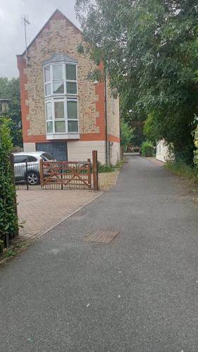 a house with a driveway in front of a building at Beautiful three story town house in Pinchbeck