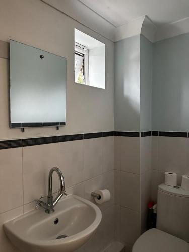 a bathroom with a sink and a toilet at Beautiful three story town house in Pinchbeck