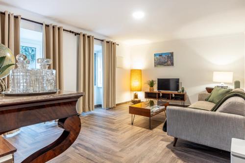 a living room with a couch and a table at Quinta Pedra Firme in Sintra