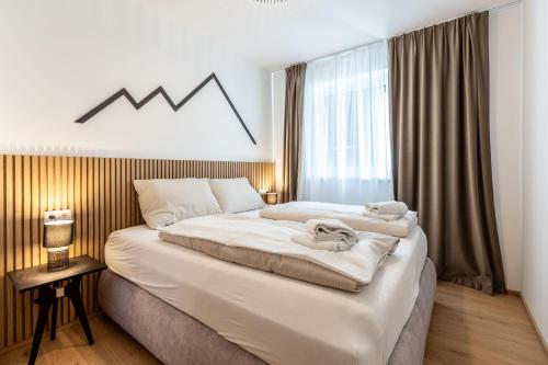 a bedroom with a large bed with a graph on the wall at Alpine Suite Spot in Bad Mitterndorf