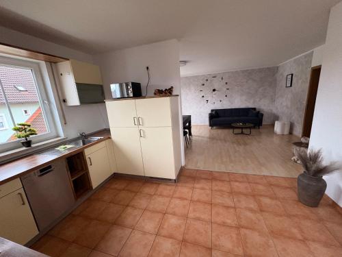 a kitchen and living room with a couch and a table at InSight Luxury Bavarian Retreat in Kemnath