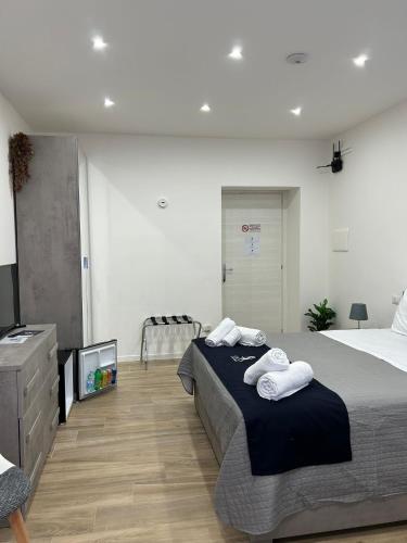 a bedroom with a bed with two towels on it at GIULY SUITES & ROOMS in Naples