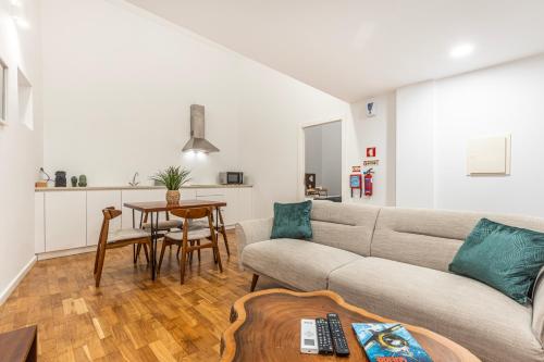 a living room with a couch and a table at Quinta Pedra Firme in Sintra