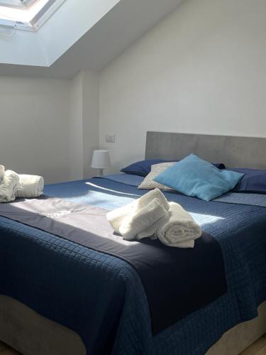 a bedroom with two beds with towels on them at GIULY SUITES & ROOMS in Naples